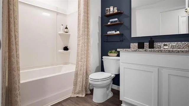 a bathroom with a sink a toilet and bathtub