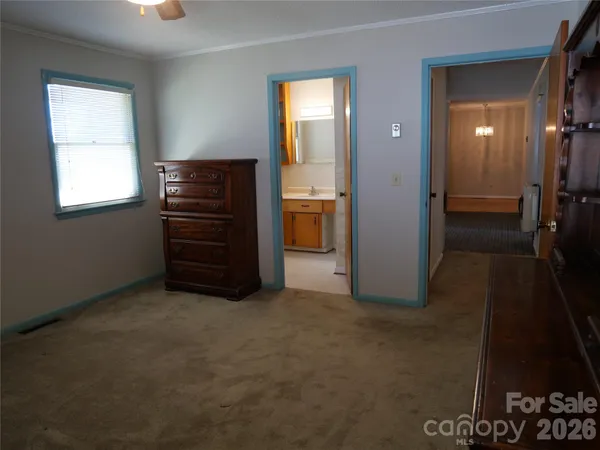 a view of hallway with a dresser and a couch