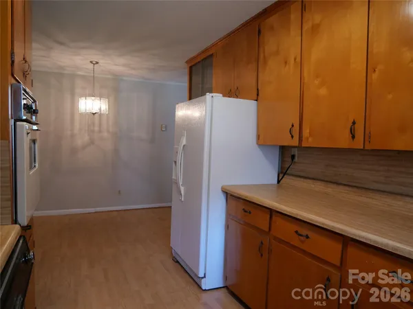 a kitchen with a refrigerator and cabinets