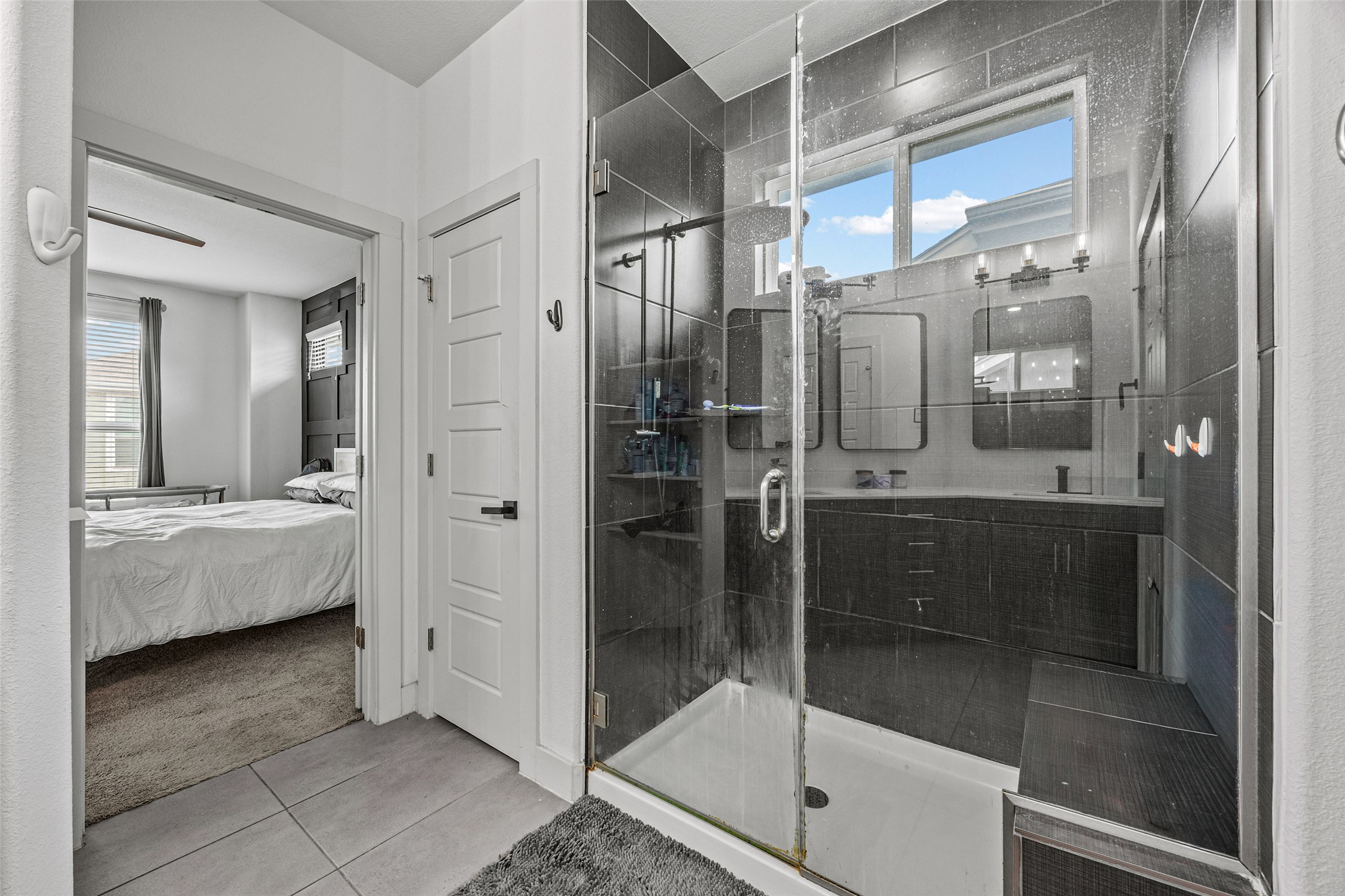 1408 Homespun Road Austin, TX 78745 - Photo 16 of 20 A well-appointed primary bathroom showcases a spacious walk-in shower and elegant vanity.