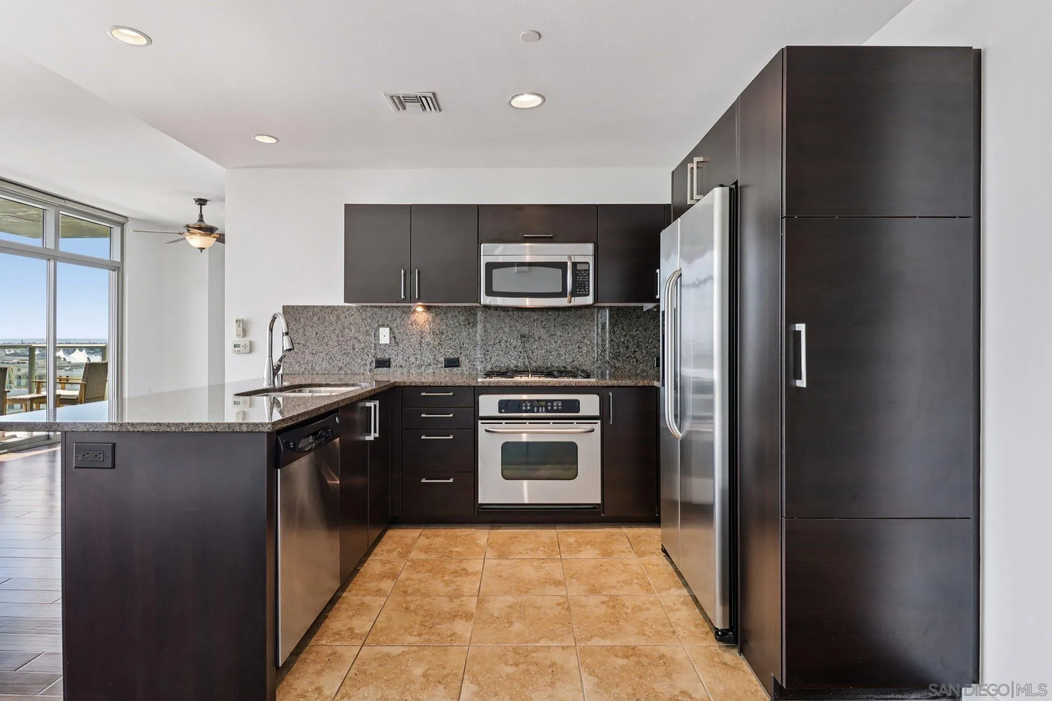 800 The Mark Lane, Unit 1606 San Diego, CA 92101 - Photo 12 of 50 a kitchen with stainless steel appliances granite countertop a refrigerator and a stove top oven
