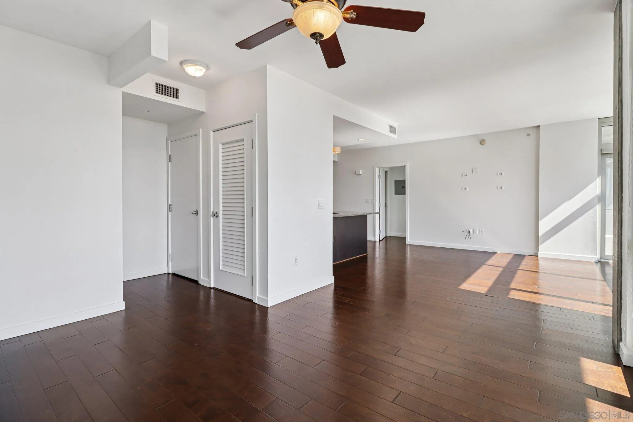 800 The Mark Lane, Unit 1606 San Diego, CA 92101 - Photo 14 of 50 a view of an empty room with wooden floor and window