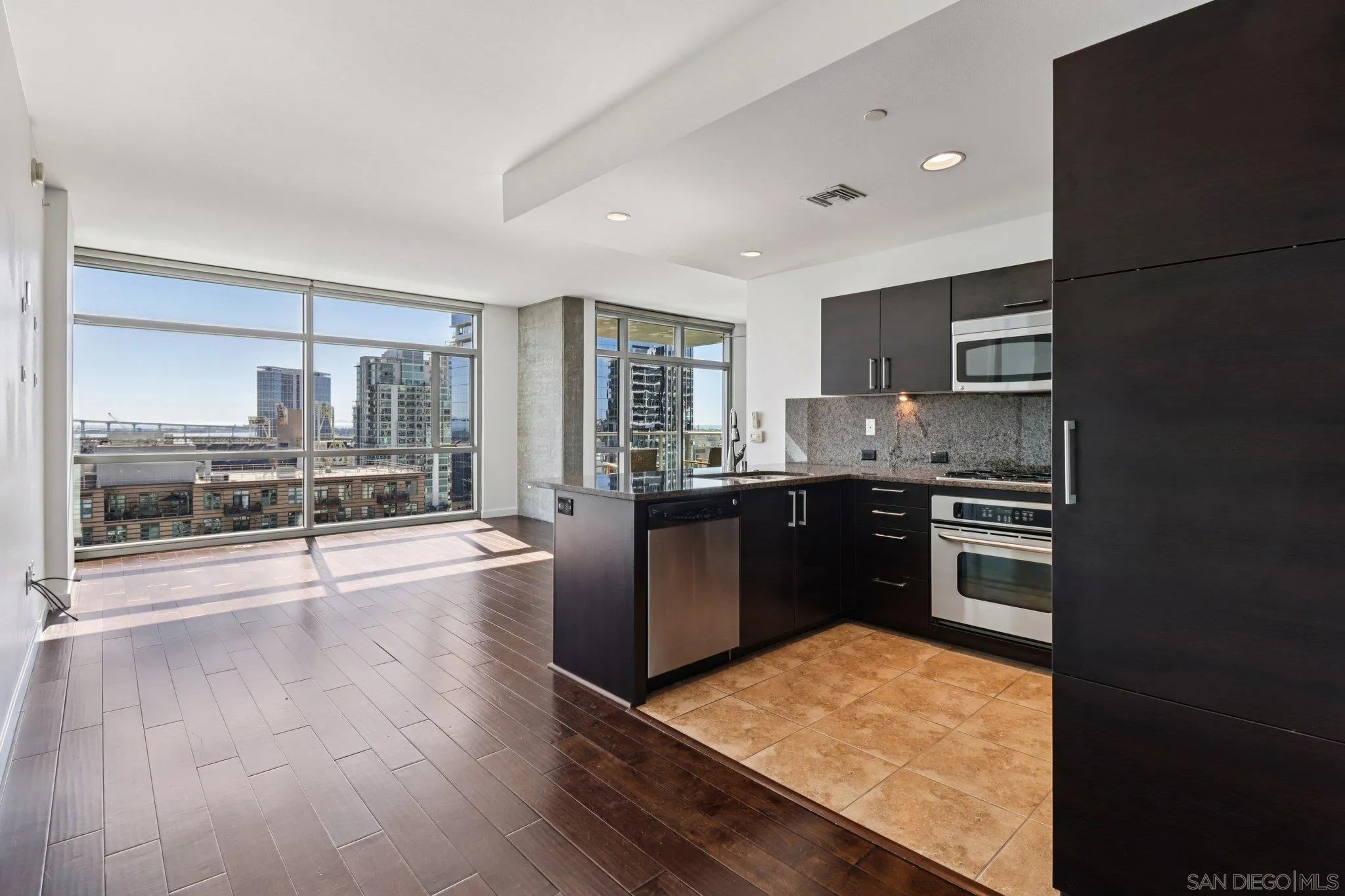 800 The Mark Lane, Unit 1606 San Diego, CA 92101 - Photo 8 of 50 a kitchen with stainless steel appliances granite countertop a stove a sink and a refrigerator