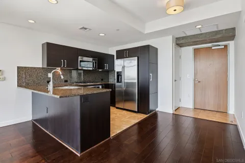 a kitchen with stainless steel appliances granite countertop a refrigerator stove and sink