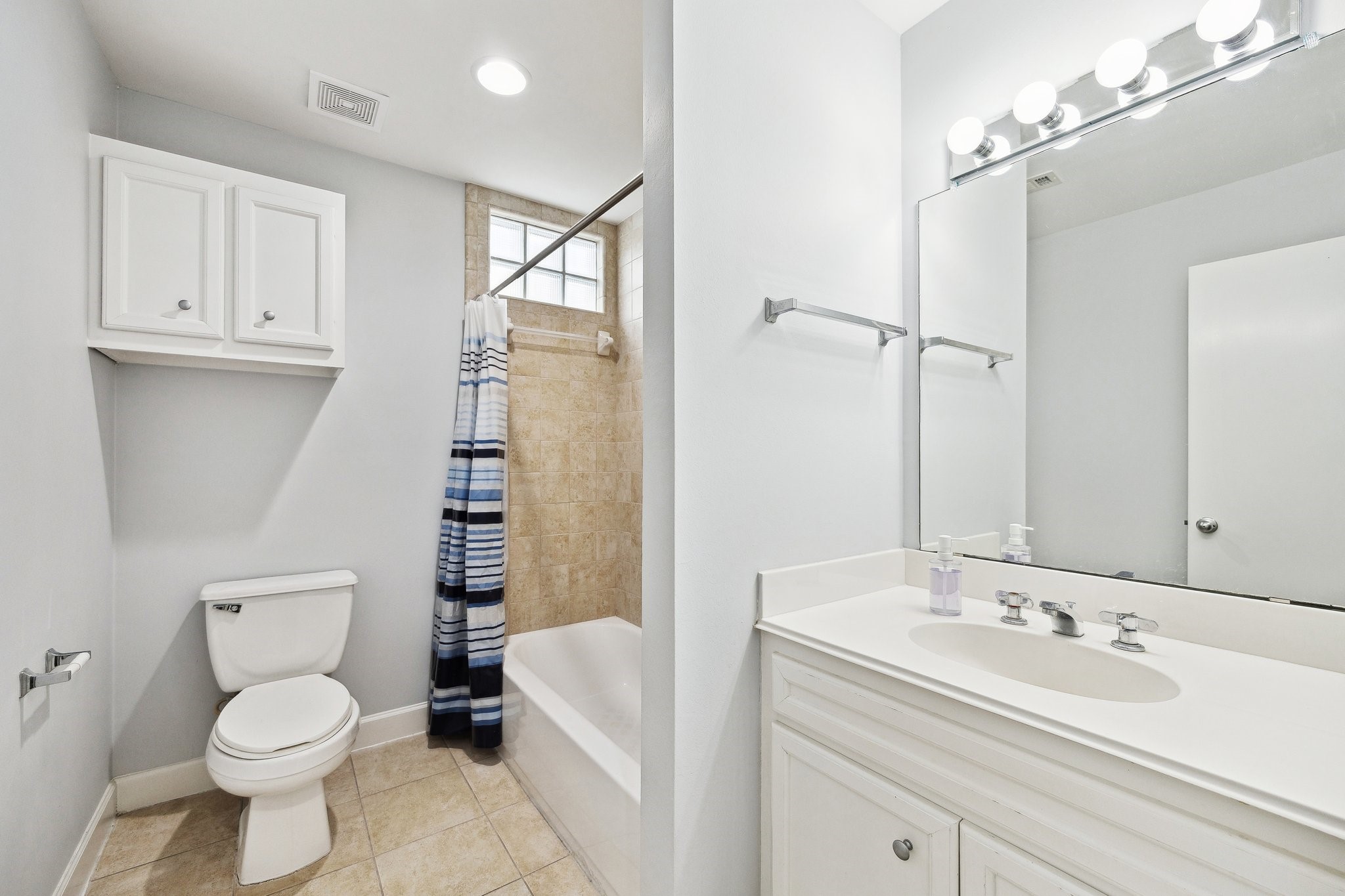 11315 South Main Street, Unit 1401 Houston, TX 77025 - Photo 11 of 14 a bathroom with a sink a toilet and shower