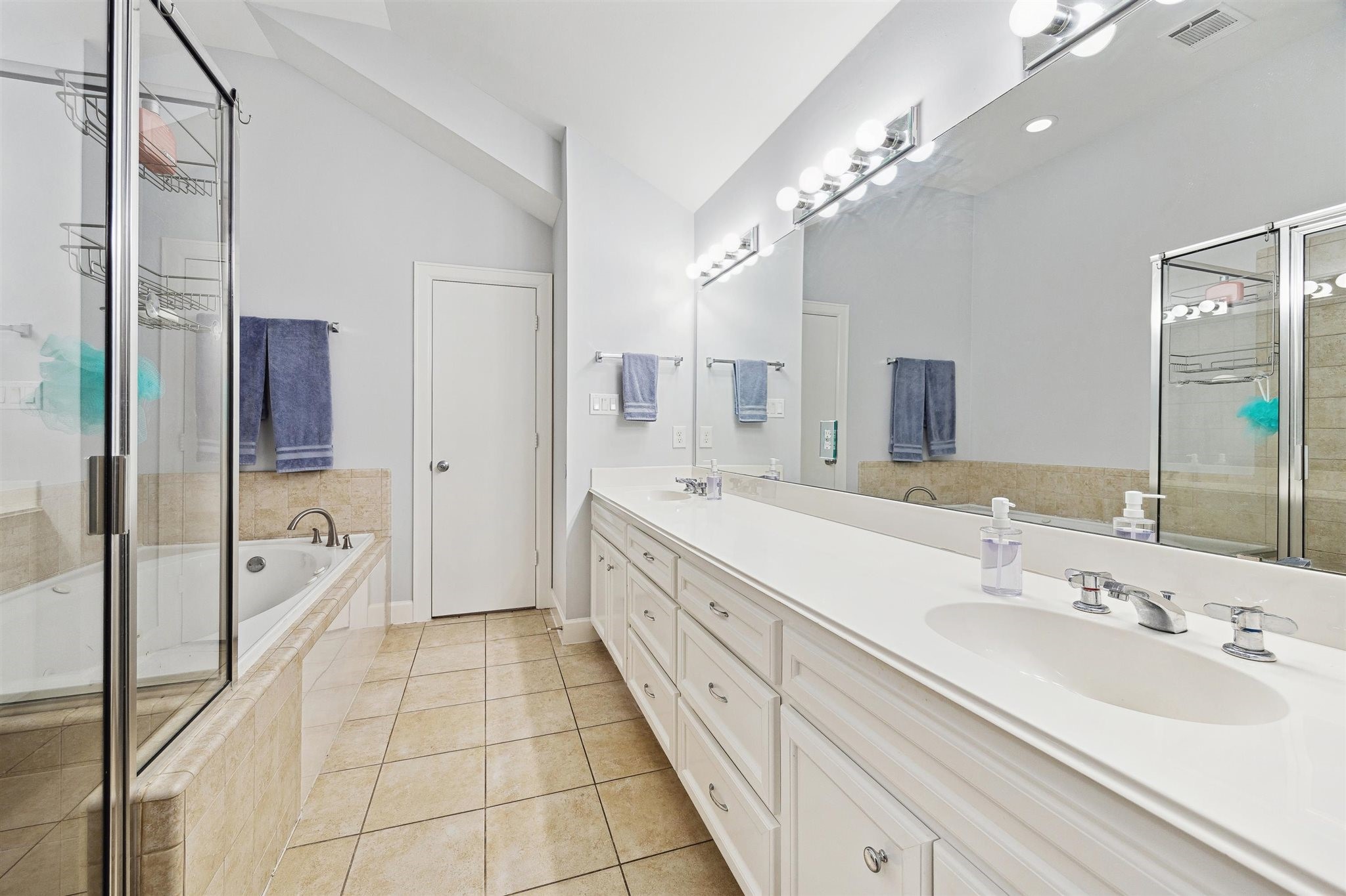 11315 South Main Street, Unit 1401 Houston, TX 77025 - Photo 8 of 14 a spacious en suite bathroom with a double vanity sink a mirror and a bathtub