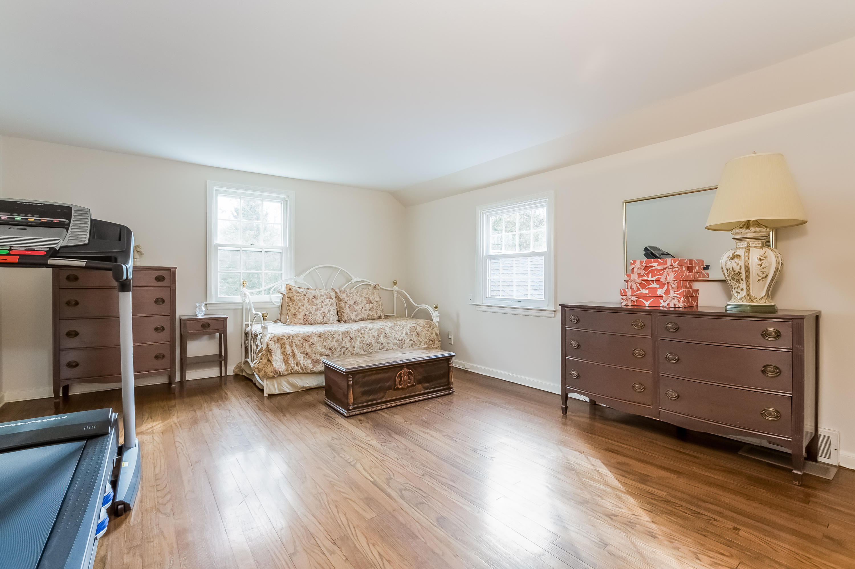 132 Colony Road Darien, CT 06820 - Photo 15 of 25 a bedroom with a bed and wooden floor