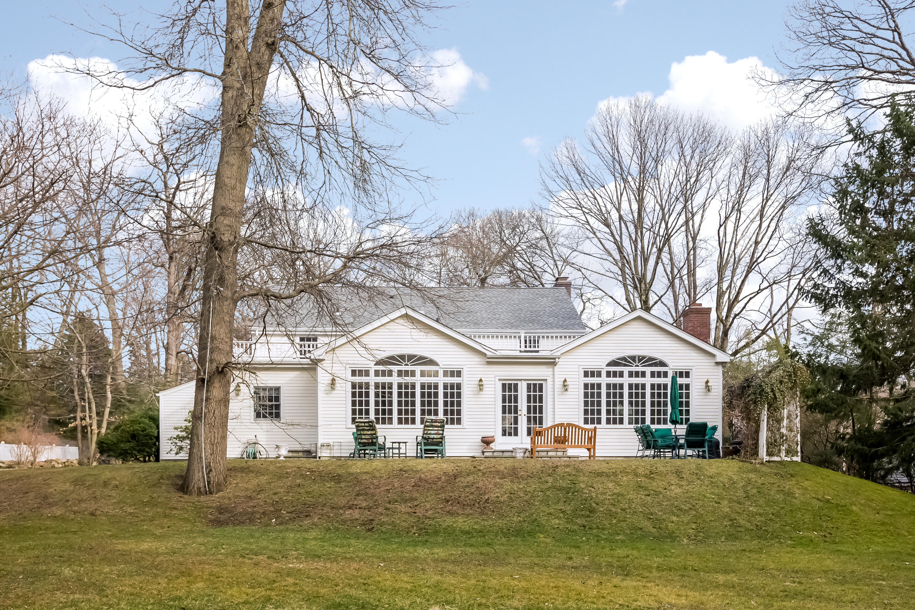 132 Colony Road Darien, CT 06820 - Photo 20 of 25 a front view of a building with a yard