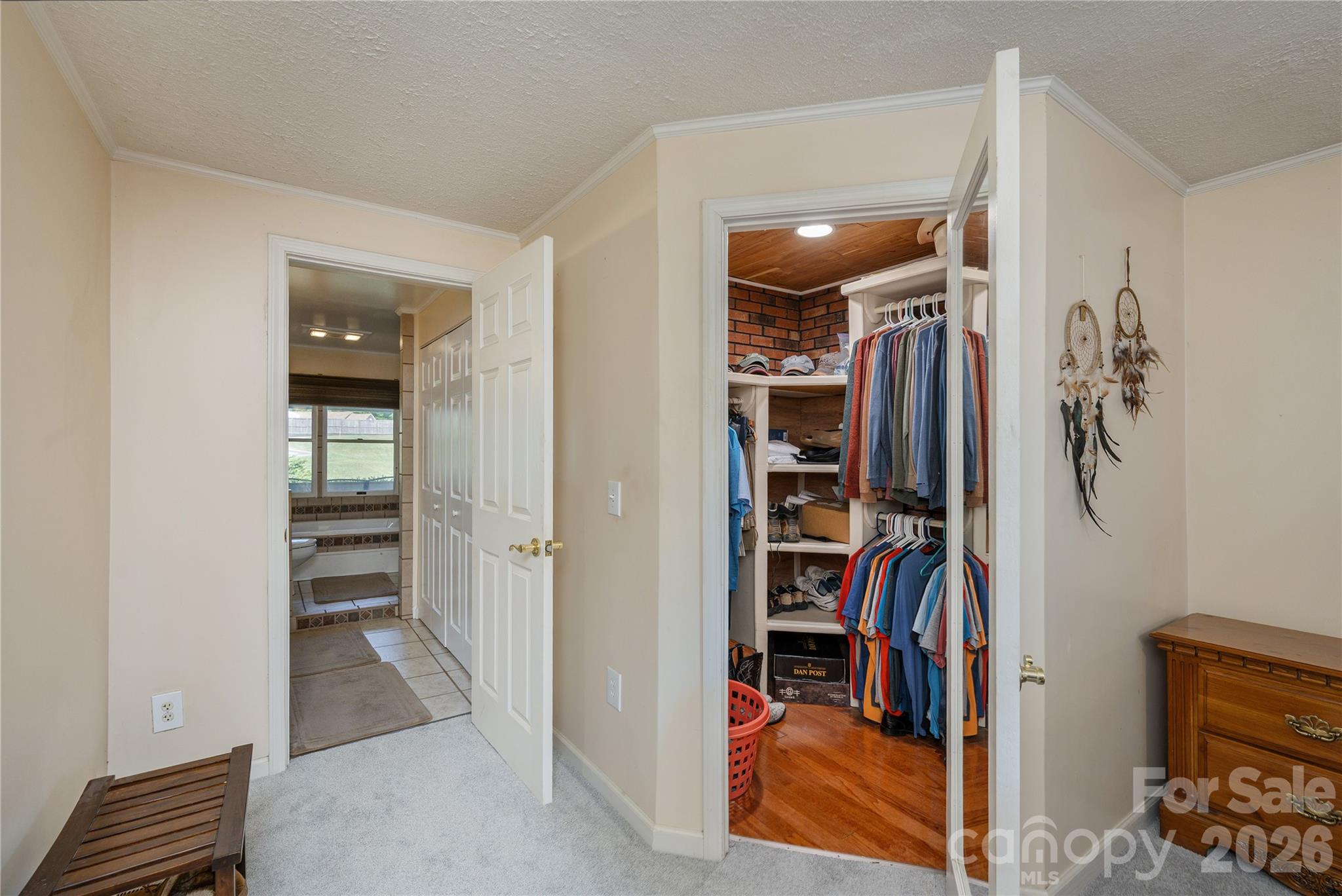 231 Allen Road East Flat Rock, NC 28726 - Photo 20 of 42 a view of walk in closet with clothes and shoes