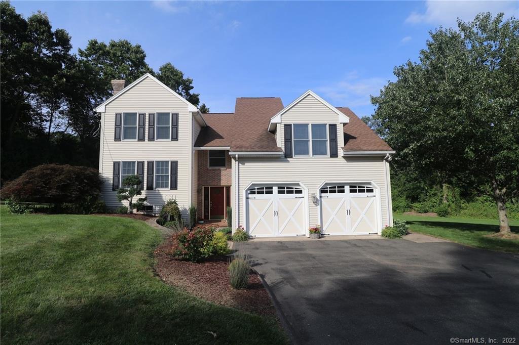 a front view of a house with a yard