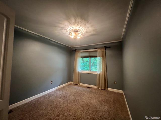 6367 Stephen Brighton, MI 48116 - Photo 13 of 16 Neutral-toned carpeting, a window with exterior views, and a decorative ceiling light fixture
