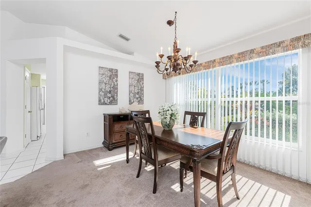 a view of a dining room with furniture and window