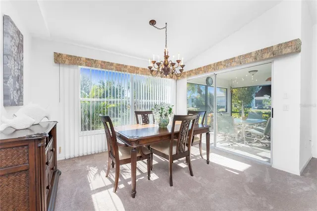 a dining room with furniture a chandelier and a rug