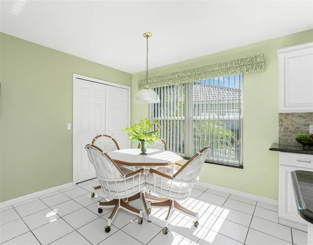 a view of a dining room with furniture wooden floor and a chandelier