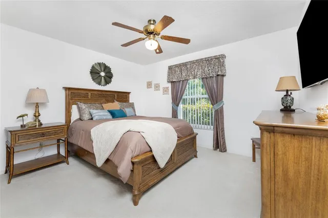 a bed room with a bed mirror and a window