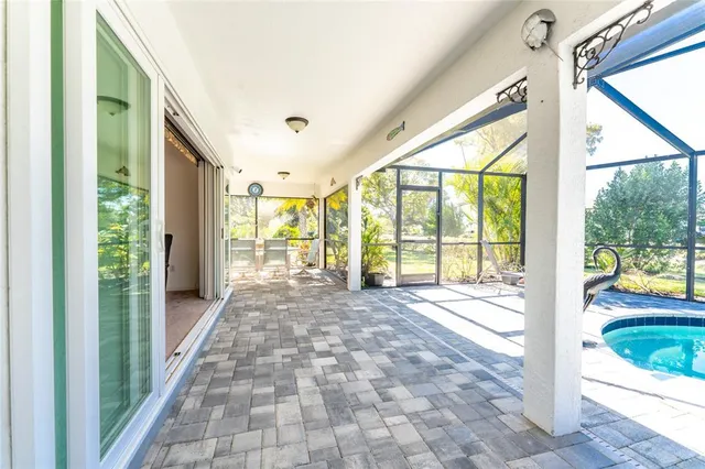 a view of hallway with a floor to ceiling window and wooden floor