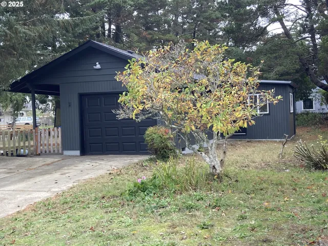 a view of a wooden house with a yard