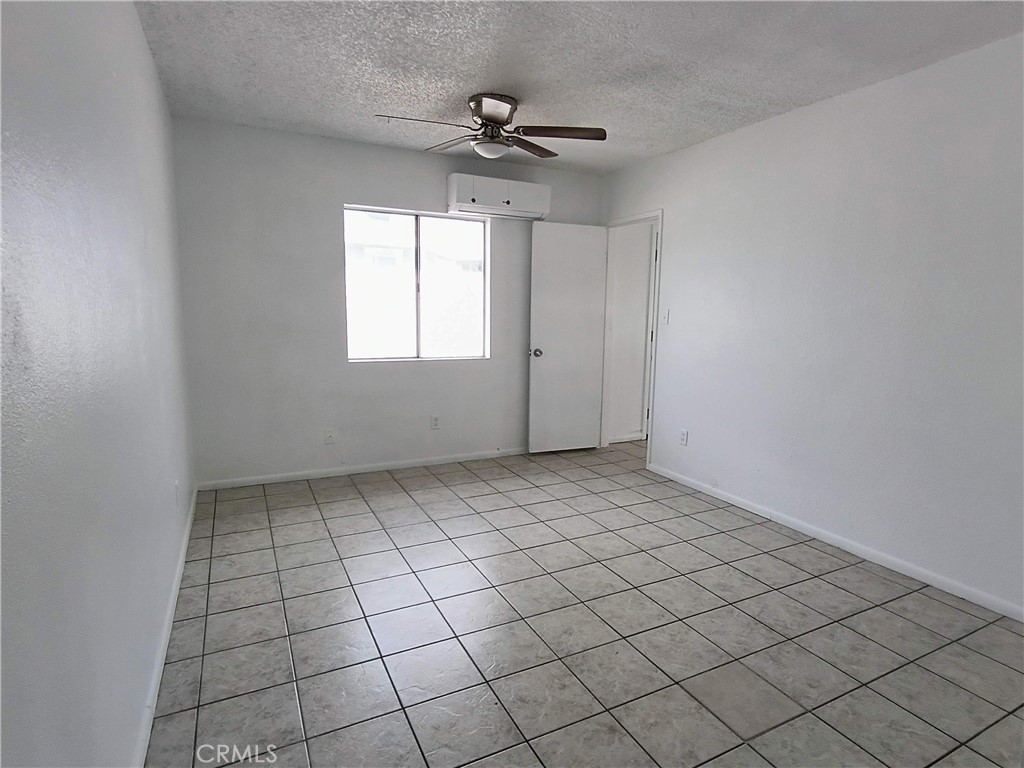 12873 Cactus Drive, Unit A Desert Hot Springs, CA 92240 - Photo 3 of 11 a view of an empty room and window