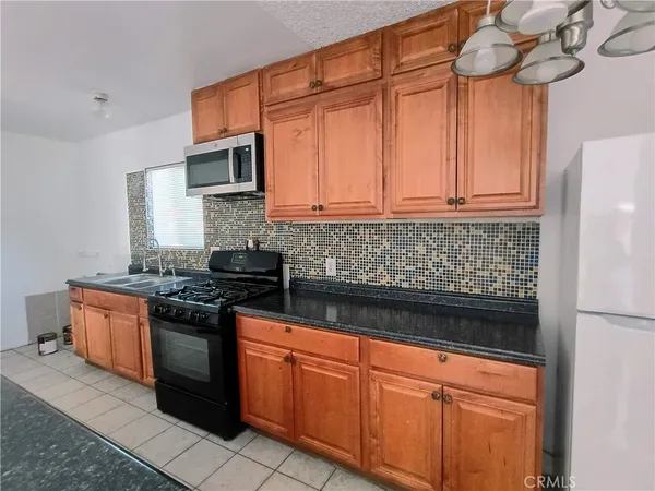 a kitchen with stainless steel appliances granite countertop a stove and a refrigerator