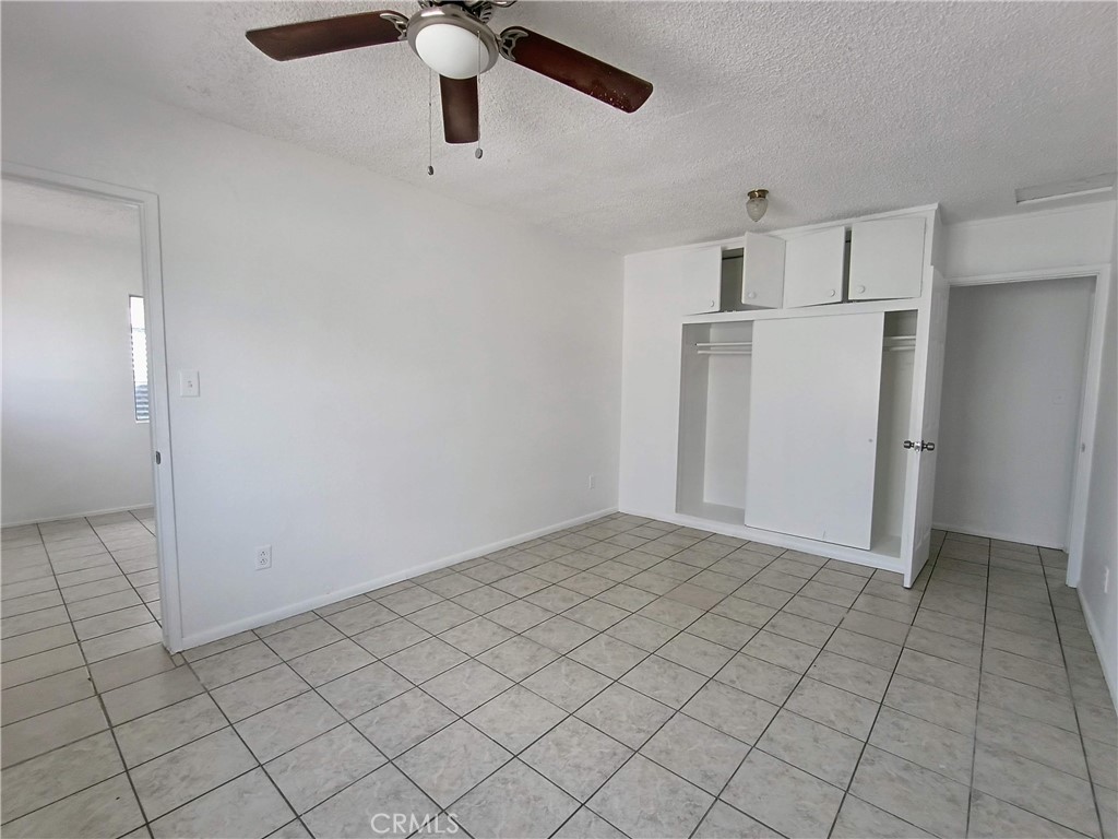 12873 Cactus Drive, Unit A Desert Hot Springs, CA 92240 - Photo 5 of 11 an empty room with closet and windows