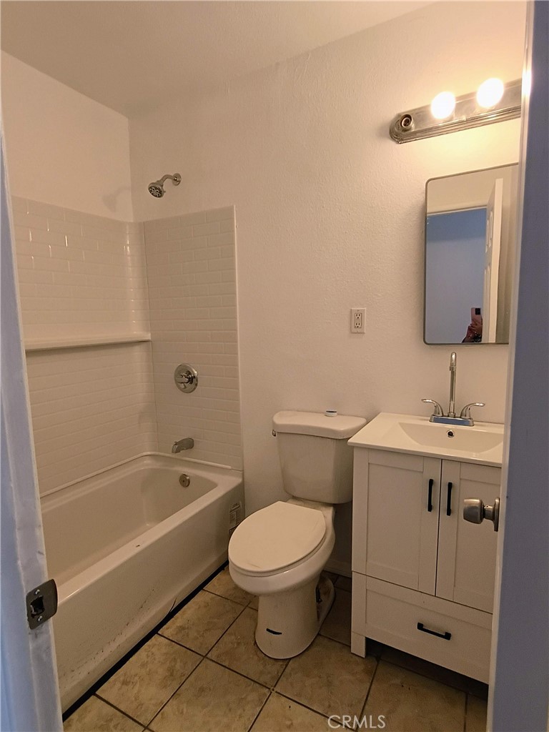 12873 Cactus Drive, Unit A Desert Hot Springs, CA 92240 - Photo 6 of 11 a bathroom with a sink a toilet and shower