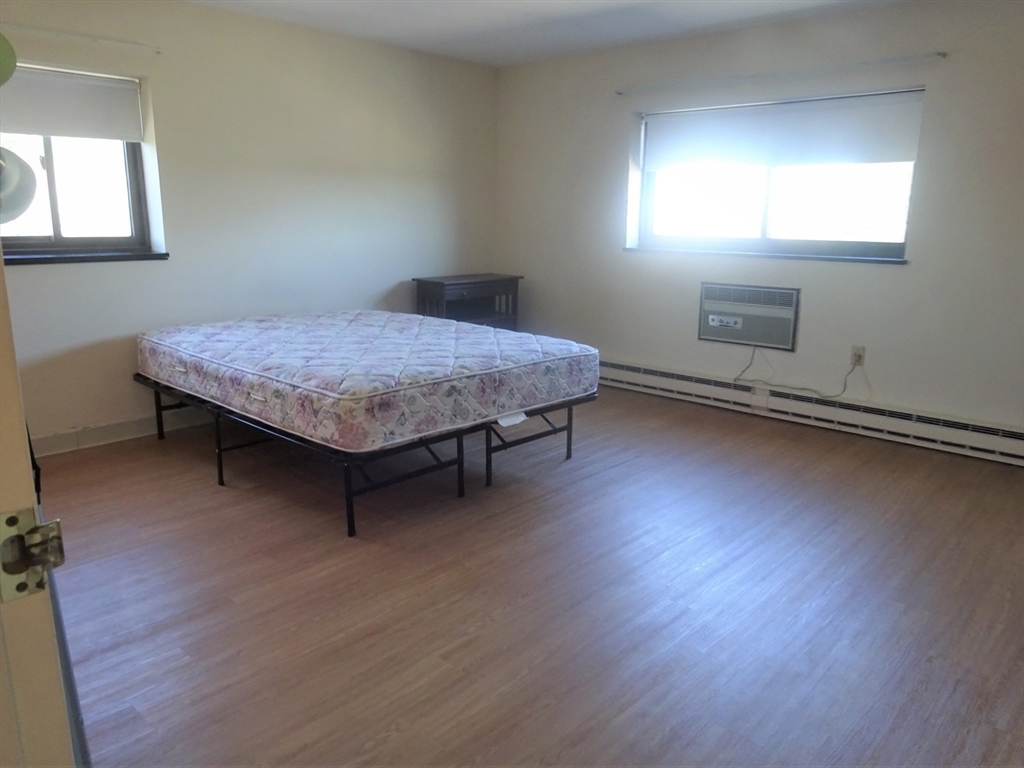 1321 Worcester Road, Unit 610 Framingham, MA 01701 - Photo 15 of 30 a bedroom with a bed and window