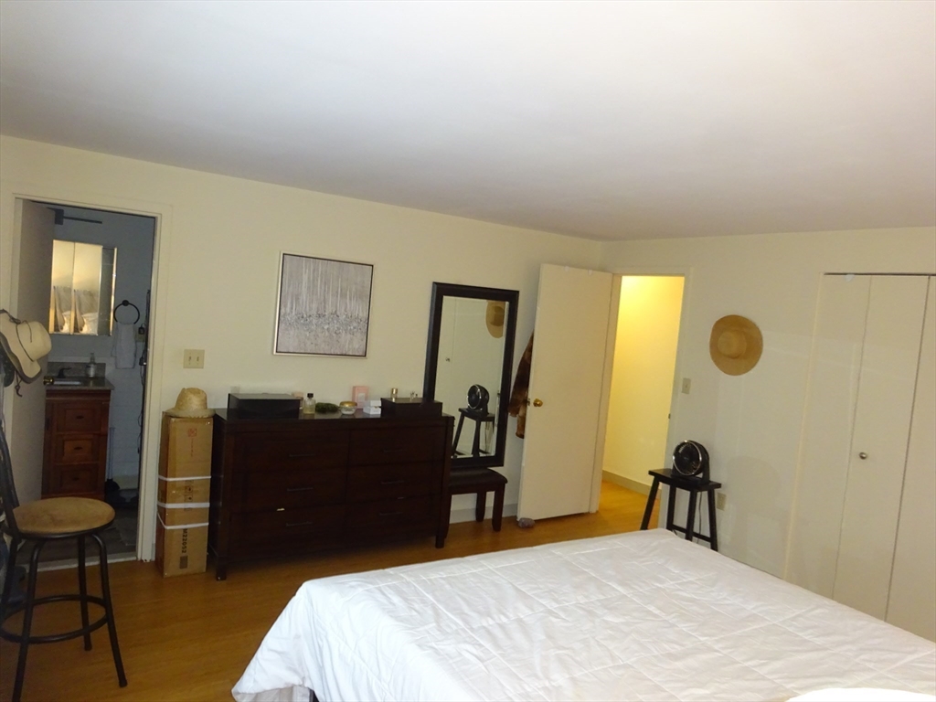 1321 Worcester Road, Unit 610 Framingham, MA 01701 - Photo 16 of 30 a bedroom with a bed and a dresser