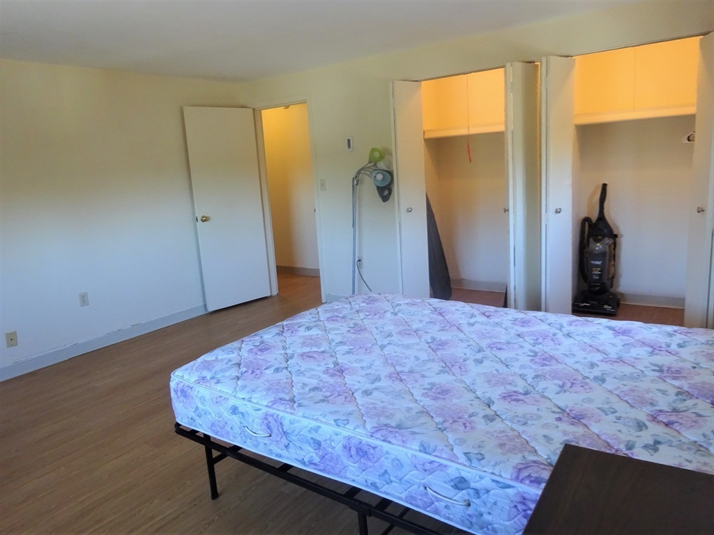 1321 Worcester Road, Unit 610 Framingham, MA 01701 - Photo 17 of 30 a bedroom with a bed and a dresser