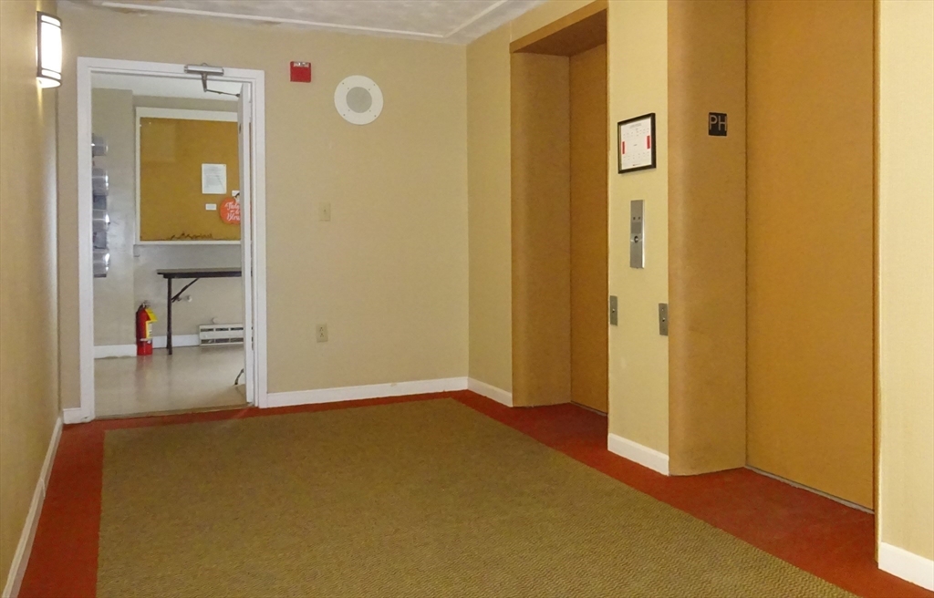 1321 Worcester Road, Unit 610 Framingham, MA 01701 - Photo 25 of 30 a view of a hallway with wooden floor
