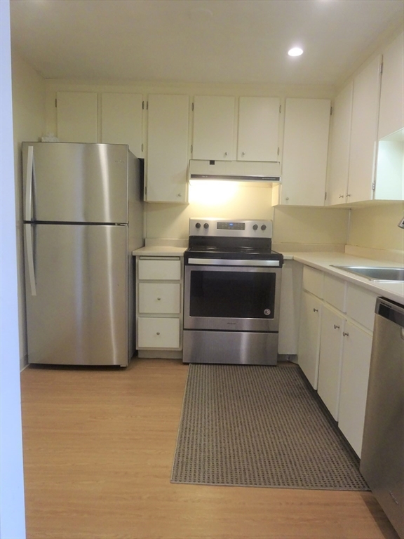 1321 Worcester Road, Unit 610 Framingham, MA 01701 - Photo 5 of 30 a kitchen with refrigerator and cabinets