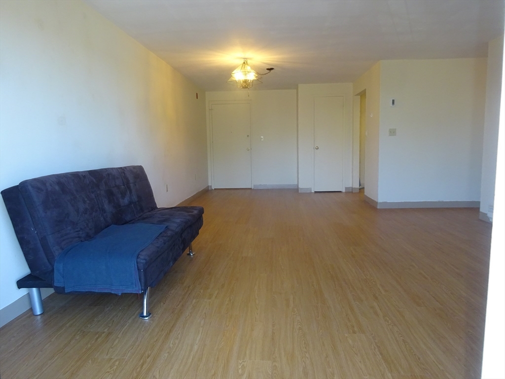 1321 Worcester Road, Unit 610 Framingham, MA 01701 - Photo 9 of 30 a living room with furniture and a lamp
