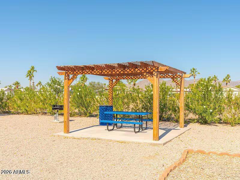 2000 South Apache Road, Unit 223 Buckeye, AZ 85326 - Photo 14 of 19 a view of an chairs and tables in the patio