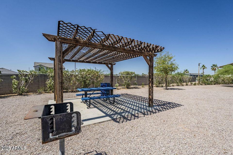 2000 South Apache Road, Unit 223 Buckeye, AZ 85326 - Photo 17 of 19 a view of a patio with a table chairs and a floor to ceiling window