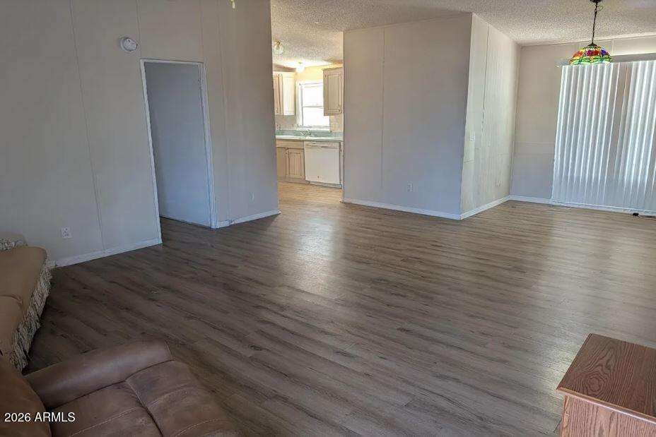 2000 South Apache Road, Unit 223 Buckeye, AZ 85326 - Photo 7 of 19 an empty room with wooden floor and windows