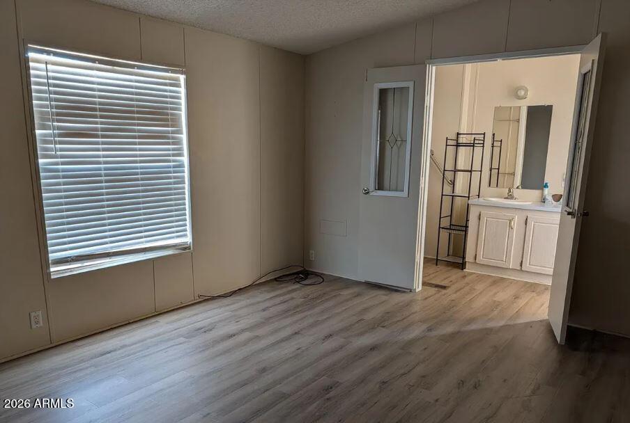 2000 South Apache Road, Unit 223 Buckeye, AZ 85326 - Photo 9 of 19 an empty room with wooden floor and a window