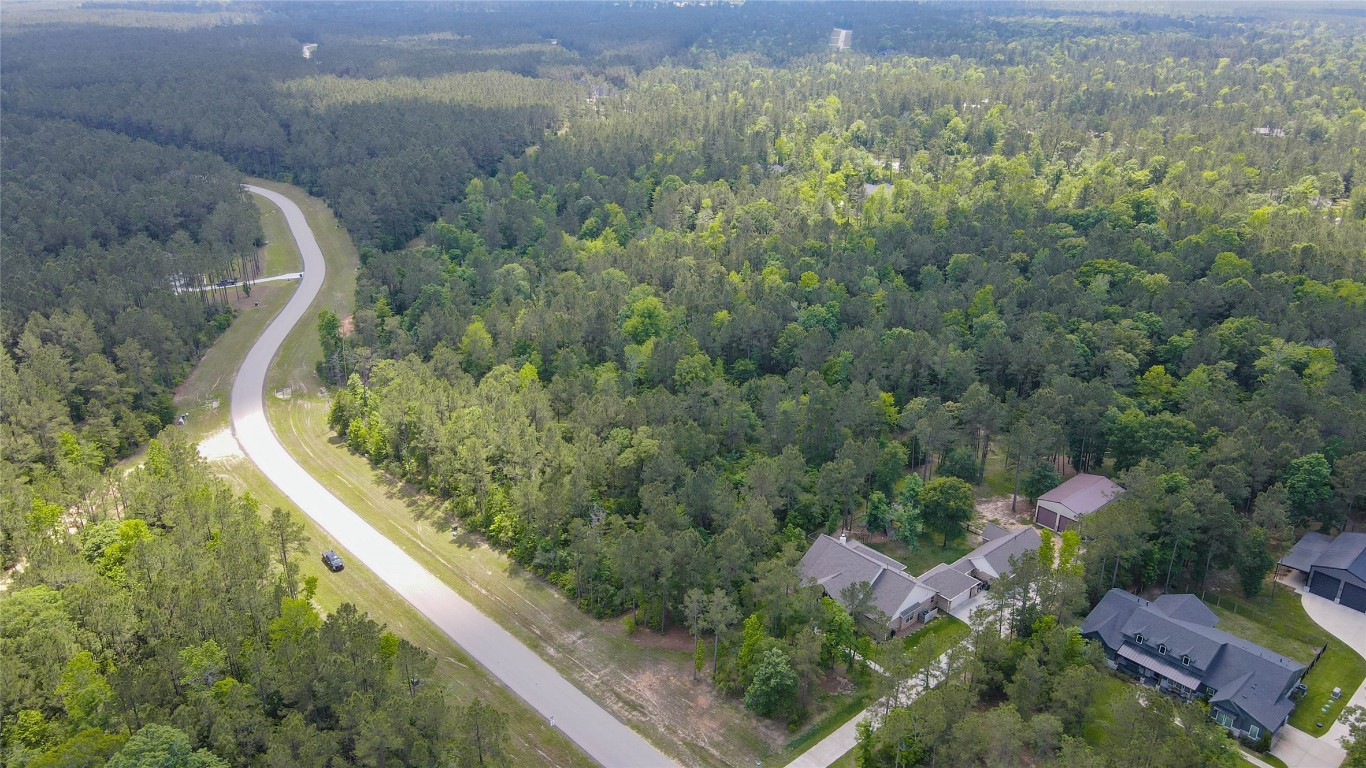 10774 Ruger Road Willis, TX 77378 - Photo 14 of 33 an aerial view of residential house with outdoor space and trees all around
