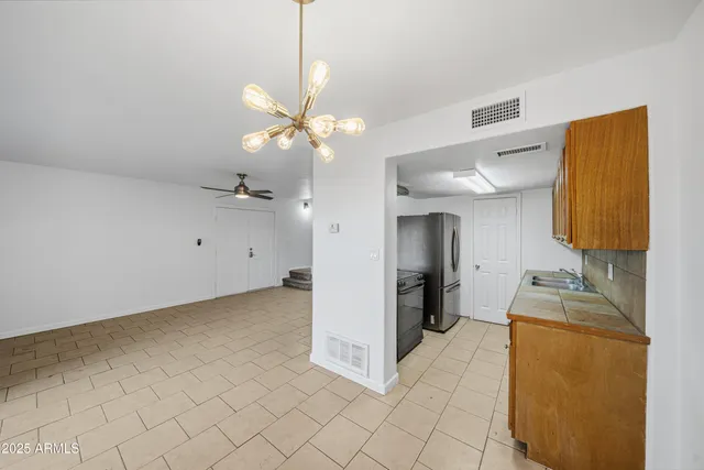 a view of a kitchen with a sink dishwasher and furniture