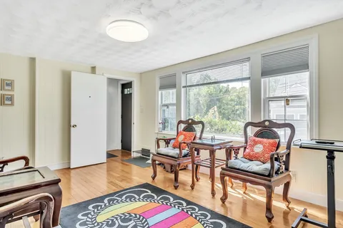 a living room with furniture and floor to ceiling windows
