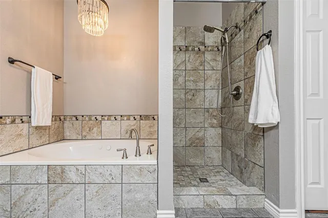 a bathroom with a bathtub and shower