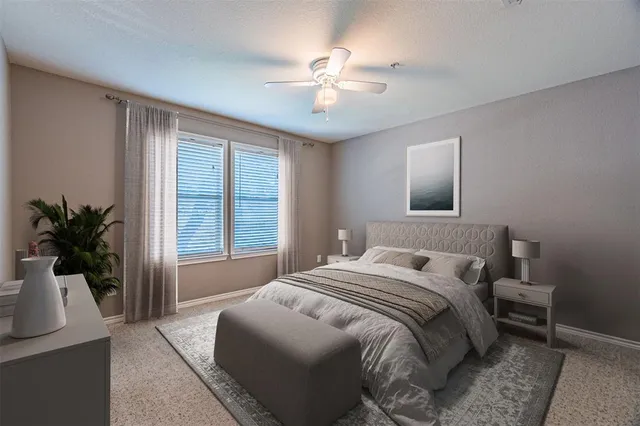 a bedroom with a large bed and a chandelier