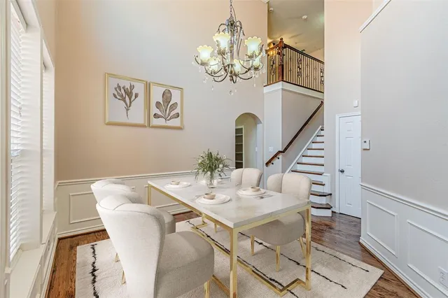 a view of a dining room with furniture wooden floor and chandelier