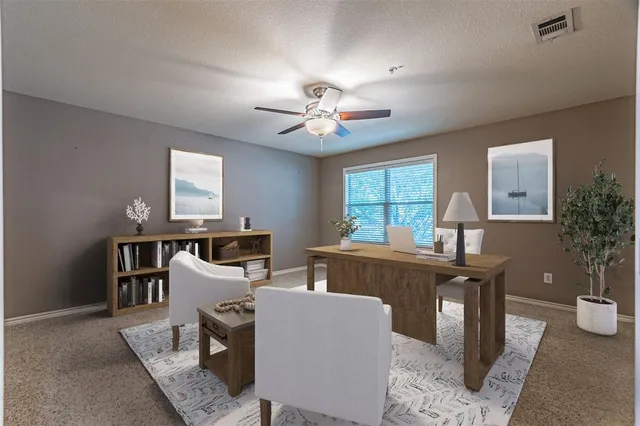 a view of a workspace with furniture and a window