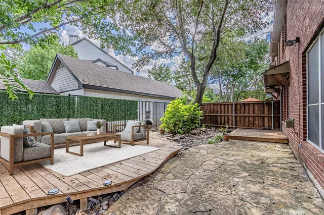 a view of a patio with couches table and chairs and potted plants