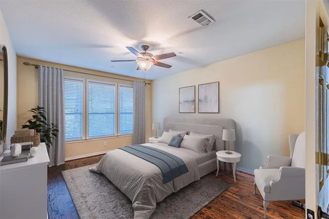 a bedroom with a large bed and a chandelier