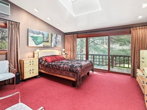 a bedroom with a bed and a large window