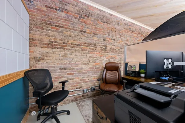 a work room with furniture and wooden floor