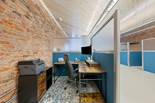 a workspace with furniture and a rug