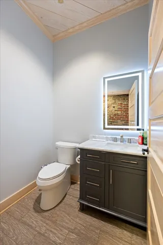 a bathroom with a sink toilet and window