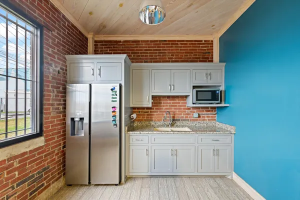 a kitchen with stainless steel appliances a stove a sink and a refrigerator