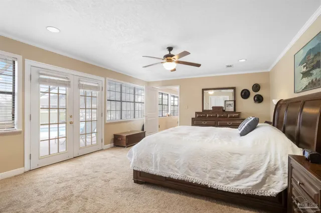 a bedroom with a large bed and a tv